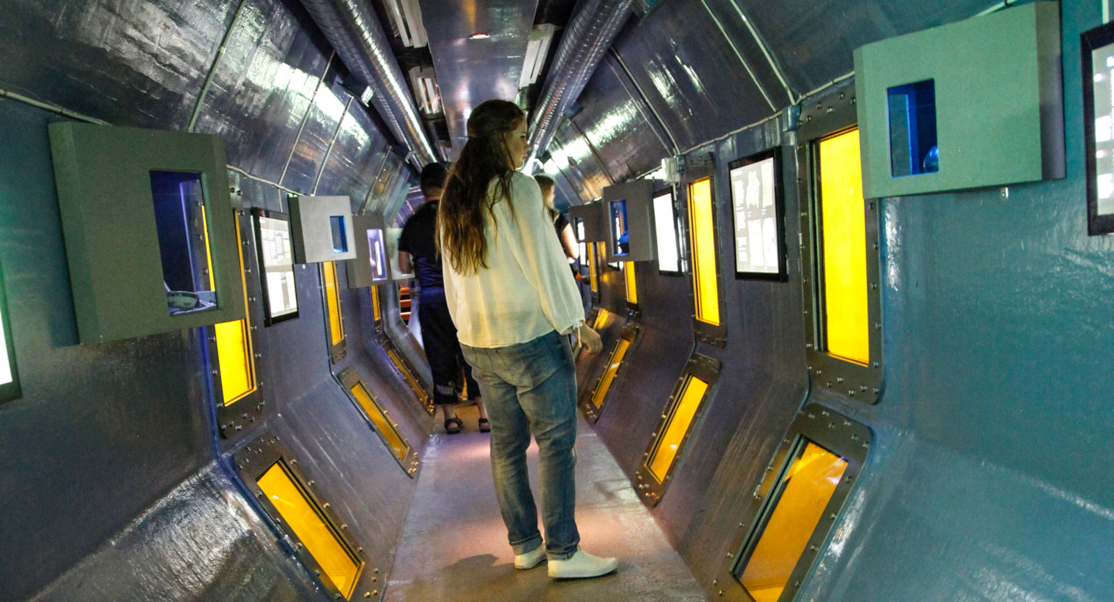 Undervattenstunnel där du kan skymta ett vrak utanför.